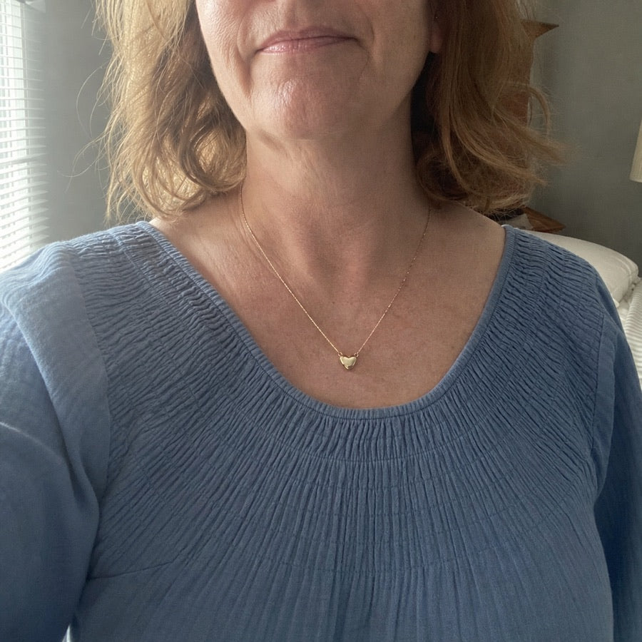 Patricia wearing her heart necklace