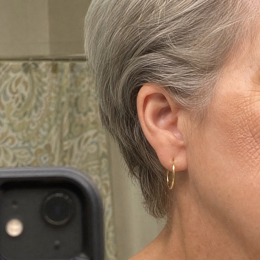 Elaine wearing her gold hoop earrings